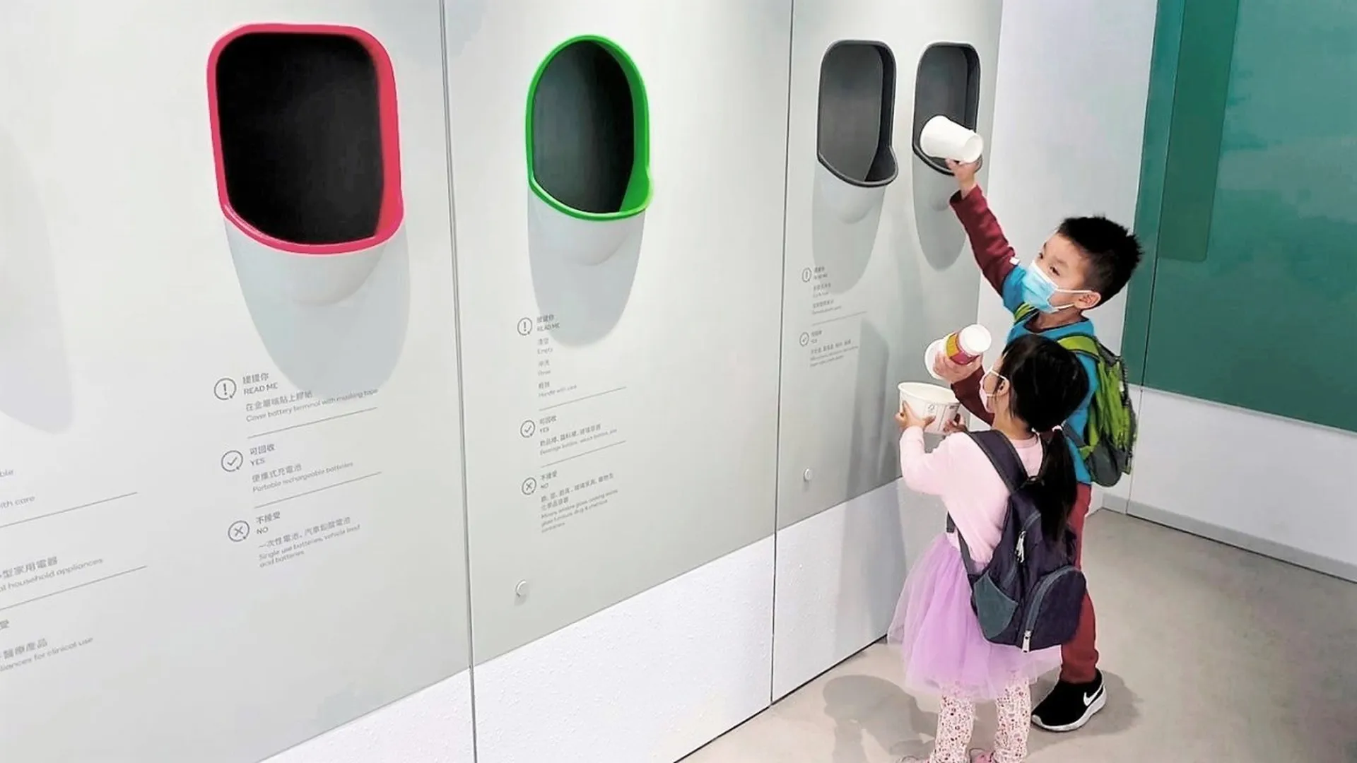 Kids practicing waste seperation and recycling in Recycling Store